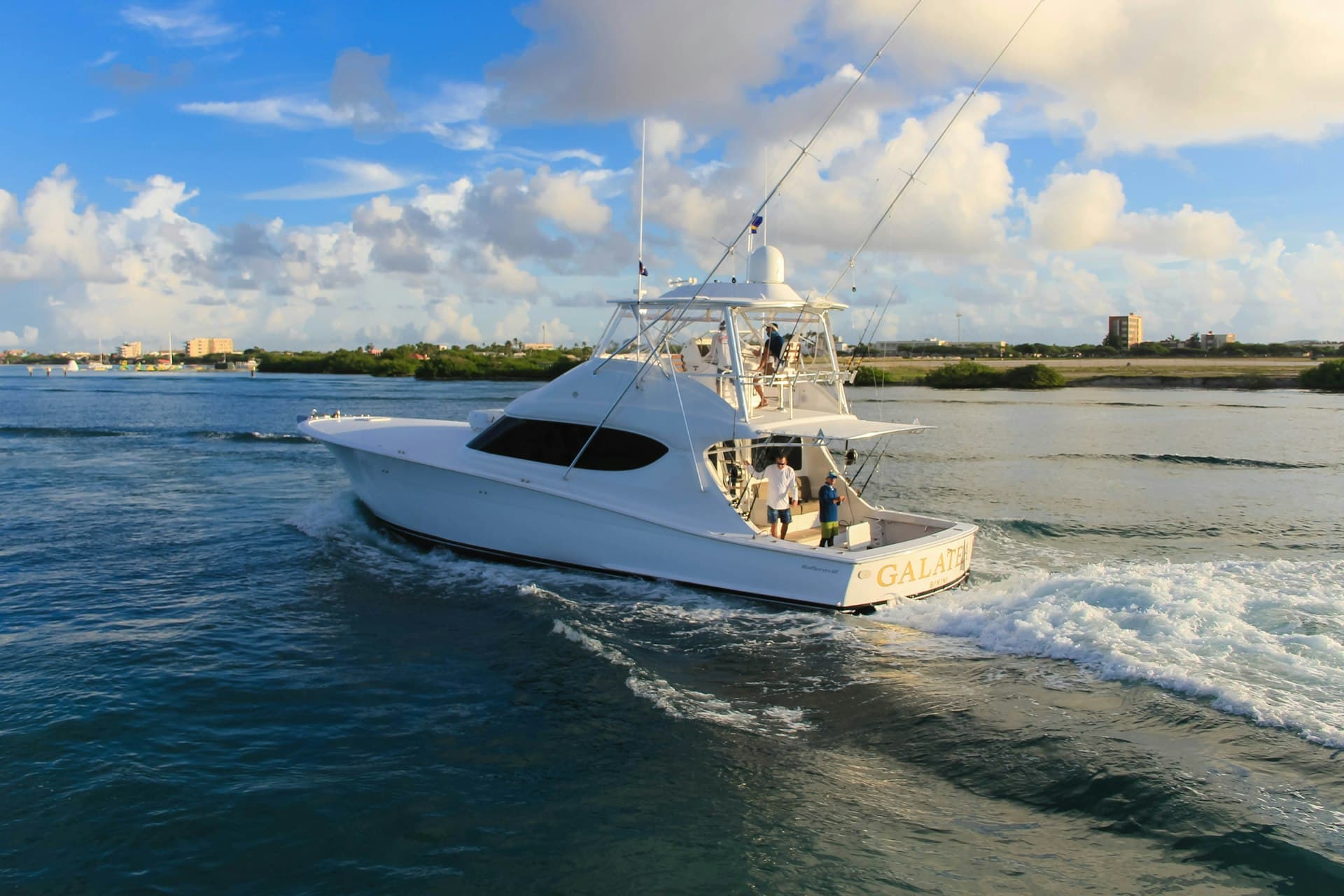A sport-fishing charter boat heading out across blue water